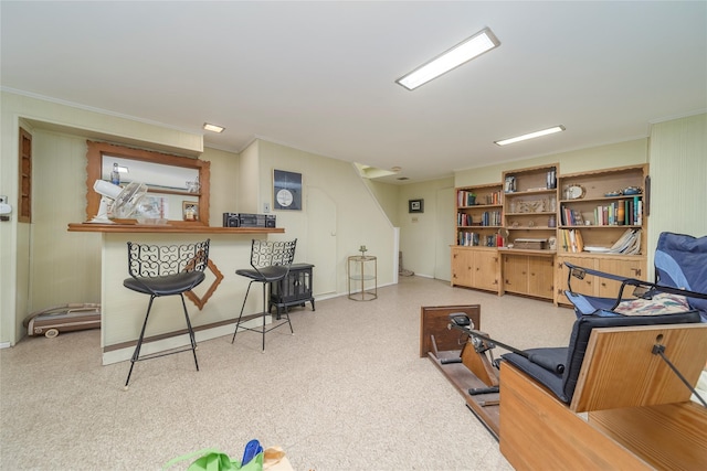 workout area featuring crown molding