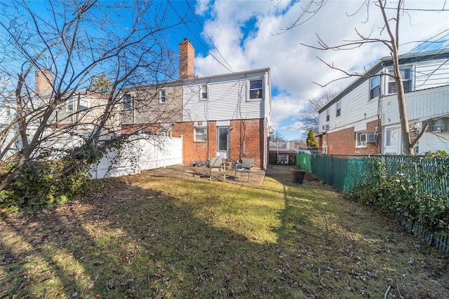 back of house featuring a patio and a yard