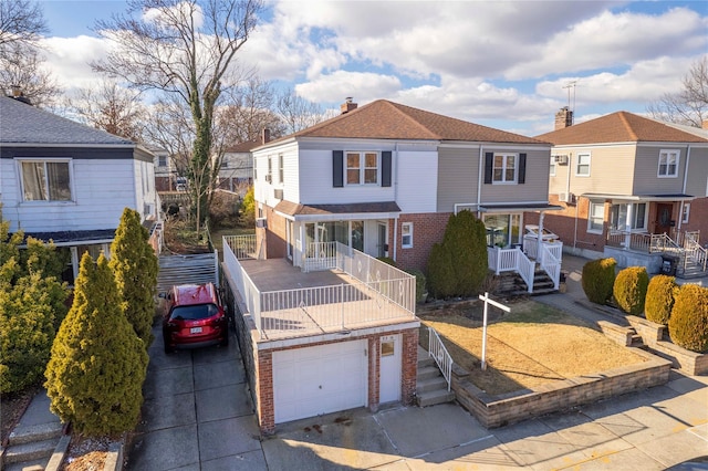 view of front of home with a garage and a balcony