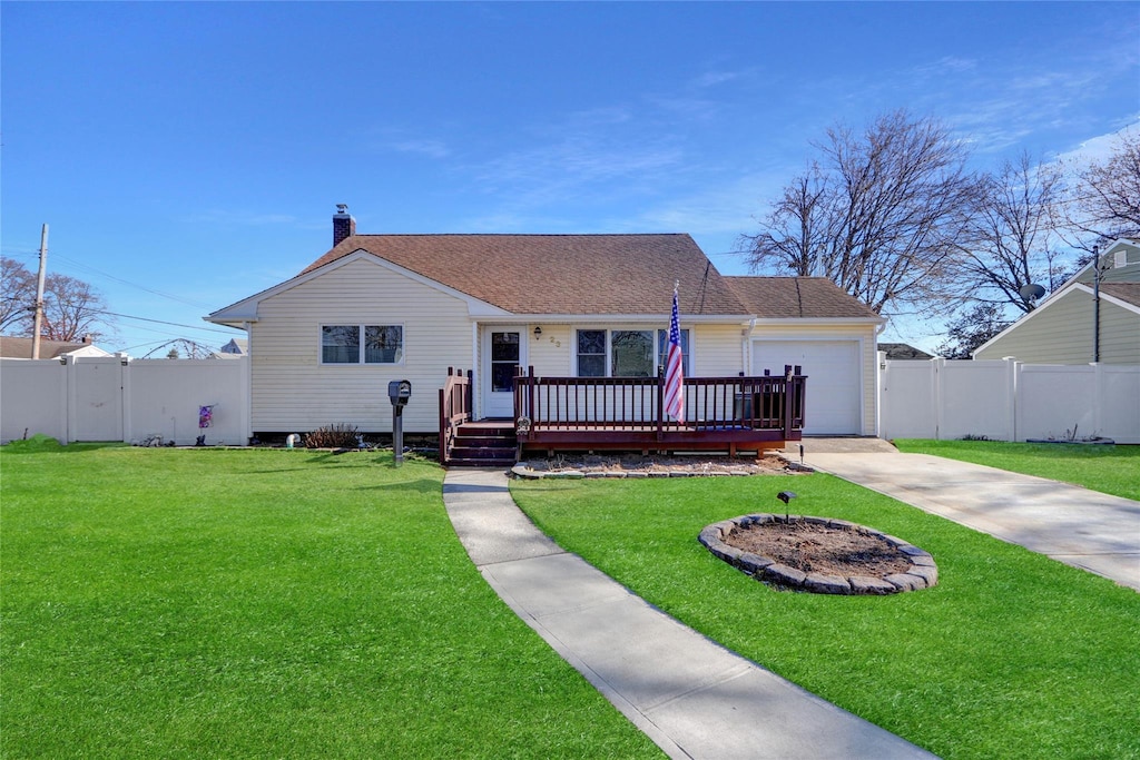 view of front of home featuring a garage, a wooden deck, and a front lawn