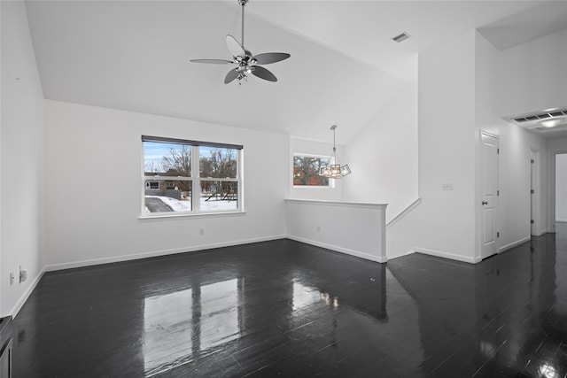 unfurnished living room featuring dark wood-type flooring, high vaulted ceiling, and ceiling fan