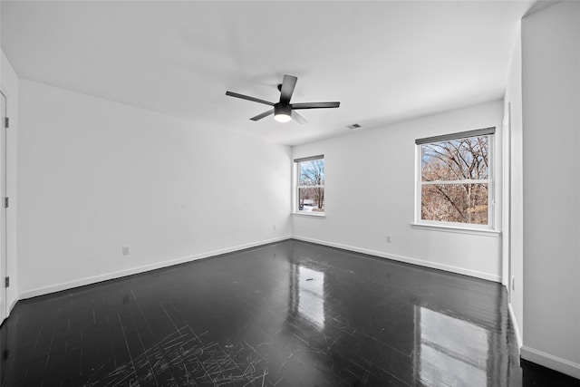 spare room with dark hardwood / wood-style floors and ceiling fan