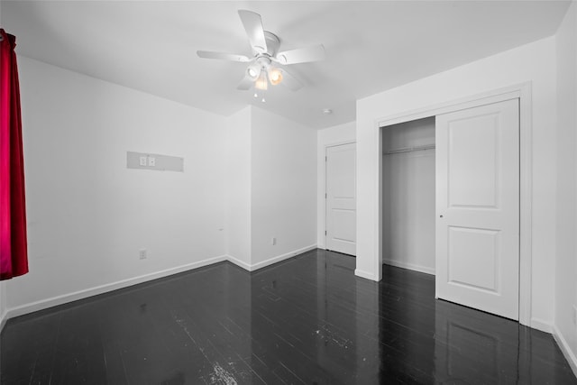 unfurnished bedroom featuring ceiling fan, dark hardwood / wood-style flooring, and a closet