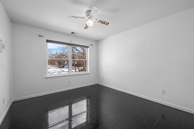 empty room with dark hardwood / wood-style floors and ceiling fan