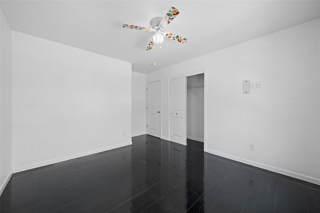 spare room featuring dark wood-type flooring and ceiling fan