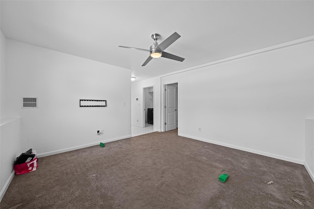 unfurnished bedroom with ceiling fan and dark colored carpet