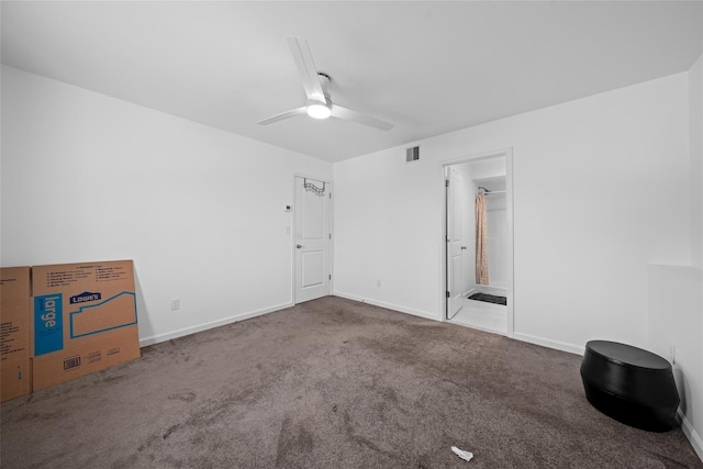 carpeted empty room featuring ceiling fan