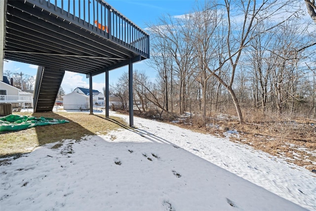 yard layered in snow featuring central AC unit