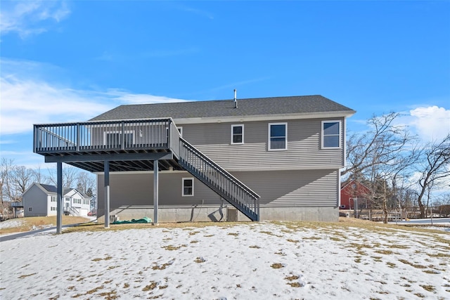 snow covered property featuring a wooden deck