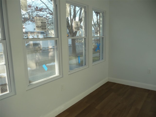 spare room with dark hardwood / wood-style floors