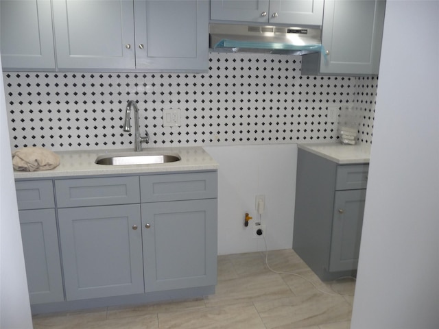 bathroom with tasteful backsplash and sink