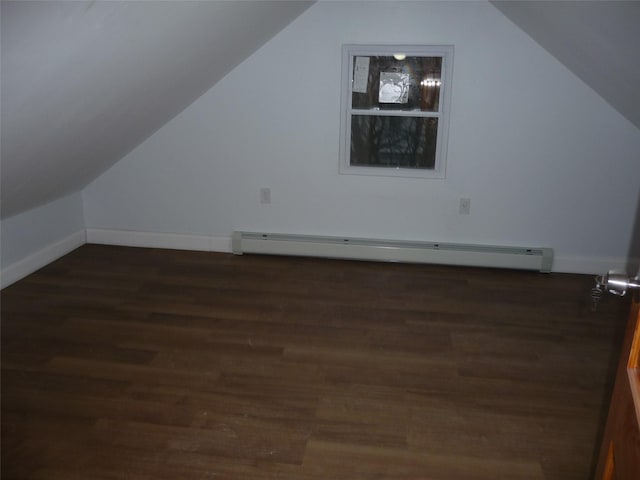 bonus room with a baseboard heating unit, vaulted ceiling, and dark hardwood / wood-style floors