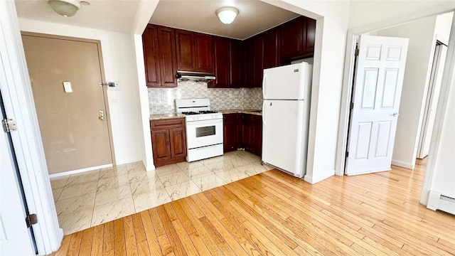 kitchen with white appliances, light hardwood / wood-style flooring, baseboard heating, light stone countertops, and decorative backsplash