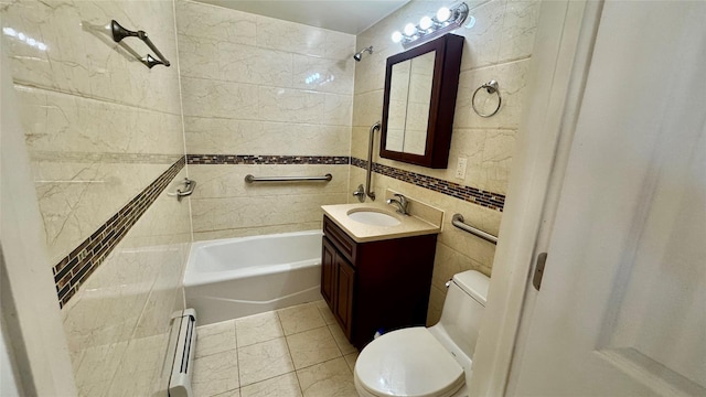 full bathroom with tile walls, tiled shower / bath combo, vanity, baseboard heating, and toilet