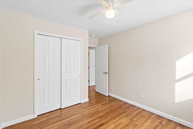 unfurnished bedroom with ceiling fan, a closet, and light hardwood / wood-style flooring