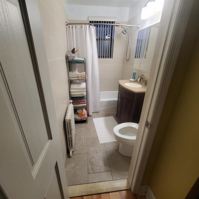 full bath with toilet, radiator heating unit, shower / bath combo with shower curtain, and vanity