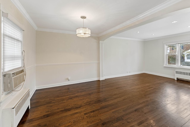 spare room with cooling unit, crown molding, radiator heating unit, and dark hardwood / wood-style floors