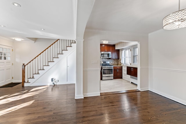 unfurnished living room with crown molding and dark hardwood / wood-style flooring