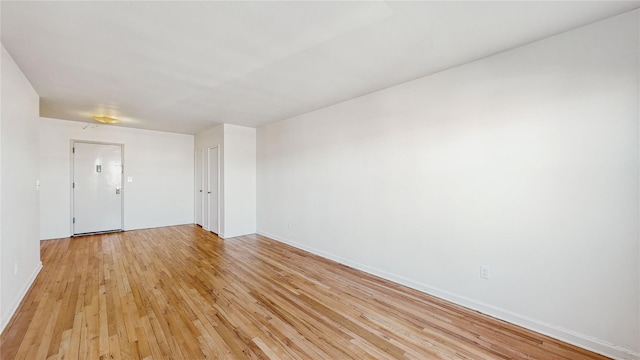 unfurnished room with light hardwood / wood-style floors