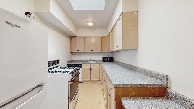 kitchen featuring sink, white appliances, light tile patterned floors, a skylight, and light brown cabinets