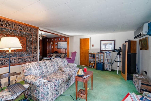 living room with ceiling fan, carpet floors, and an AC wall unit