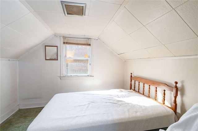 bedroom with vaulted ceiling and dark colored carpet