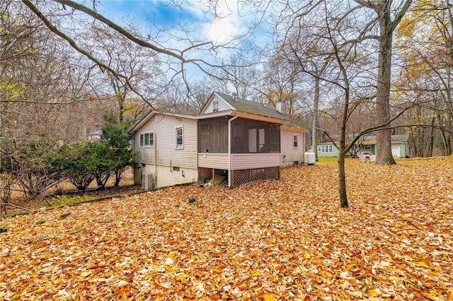 view of home's exterior with a sunroom and cooling unit