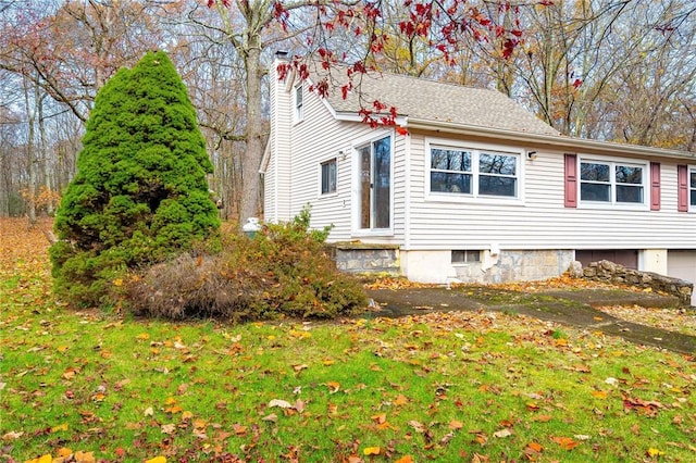 view of home's exterior with a lawn