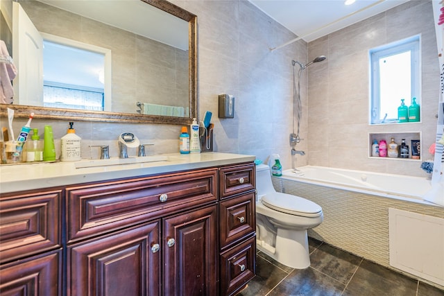 full bathroom with tile walls, a wealth of natural light, toilet, and tiled shower / bath