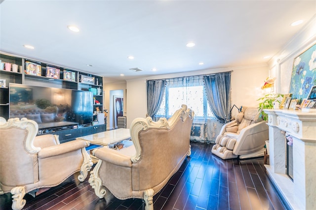 living room with crown molding and a fireplace