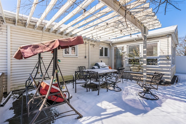 snow covered patio featuring a pergola