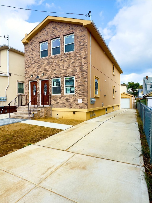 view of front of home with a garage and an outdoor structure