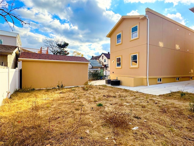 view of side of home featuring cooling unit