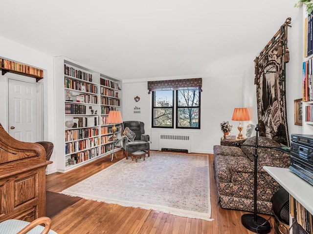 sitting room featuring hardwood / wood-style flooring and radiator heating unit