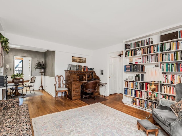 sitting room with dark wood-type flooring