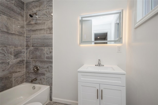 bathroom featuring vanity and tiled shower / bath