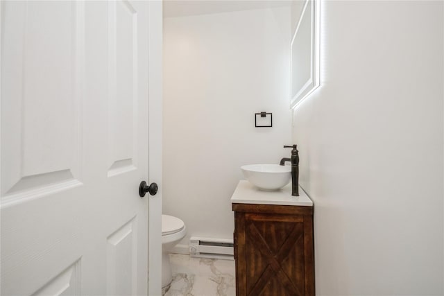 bathroom with vanity, baseboard heating, and toilet