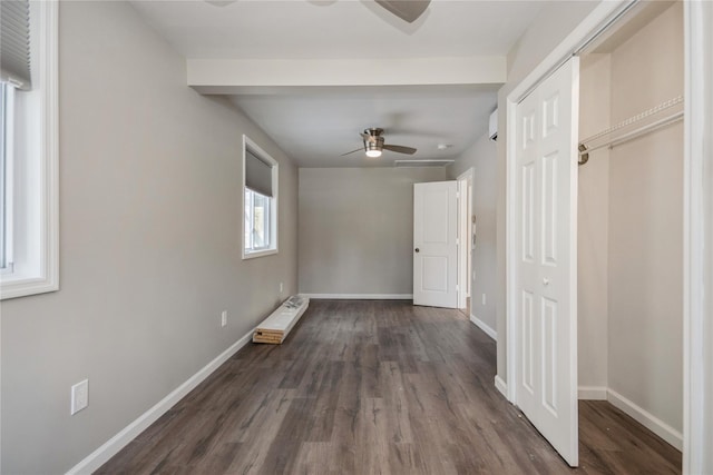 unfurnished bedroom with ceiling fan and dark hardwood / wood-style flooring