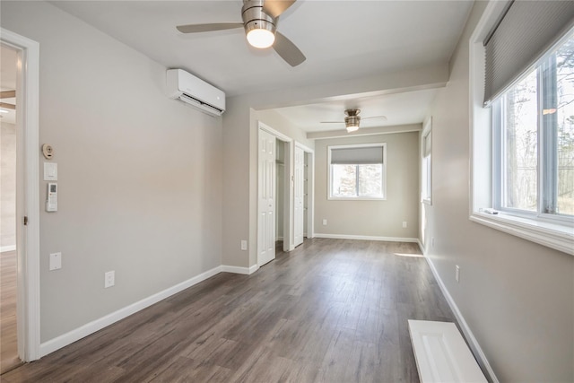 empty room with a wall mounted air conditioner, dark hardwood / wood-style floors, and ceiling fan