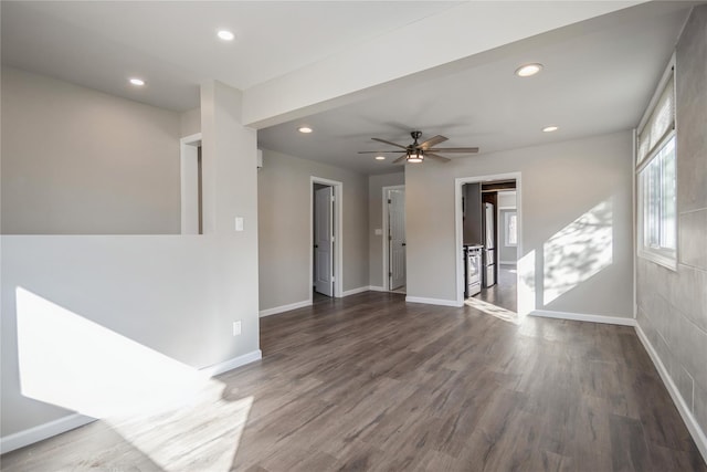 empty room with dark wood-type flooring and ceiling fan