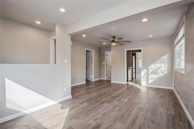 empty room featuring hardwood / wood-style floors and ceiling fan