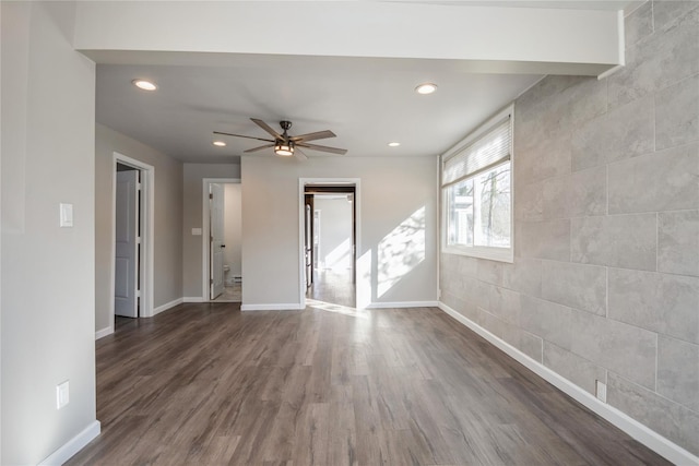 empty room featuring ceiling fan and dark hardwood / wood-style flooring