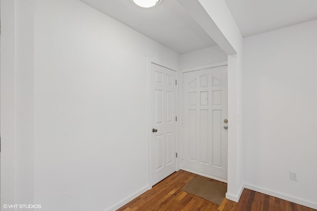 hallway with dark hardwood / wood-style floors