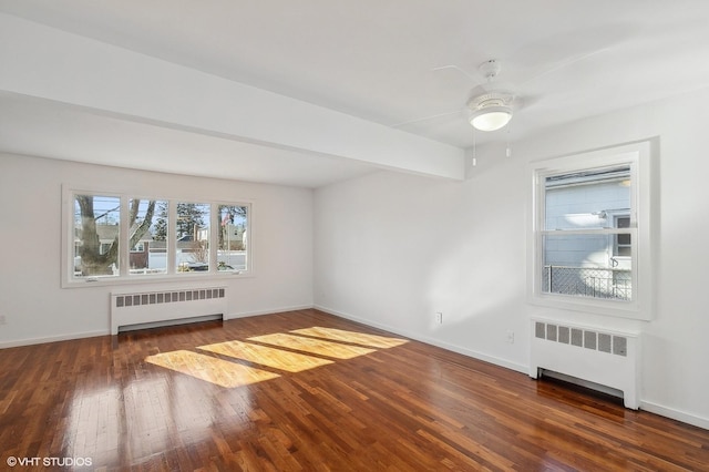 unfurnished room with beamed ceiling, dark hardwood / wood-style floors, and radiator