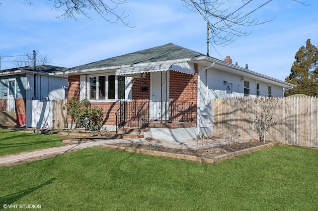 bungalow-style home featuring a chimney, fence, a front lawn, and brick siding