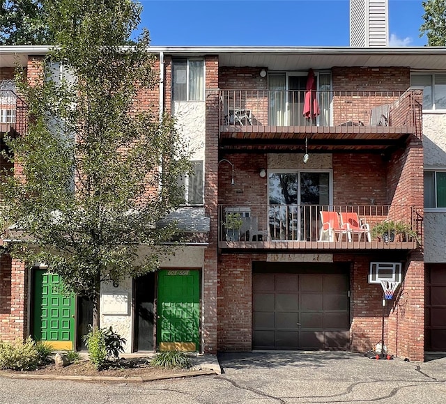 view of front of home with a balcony and a garage