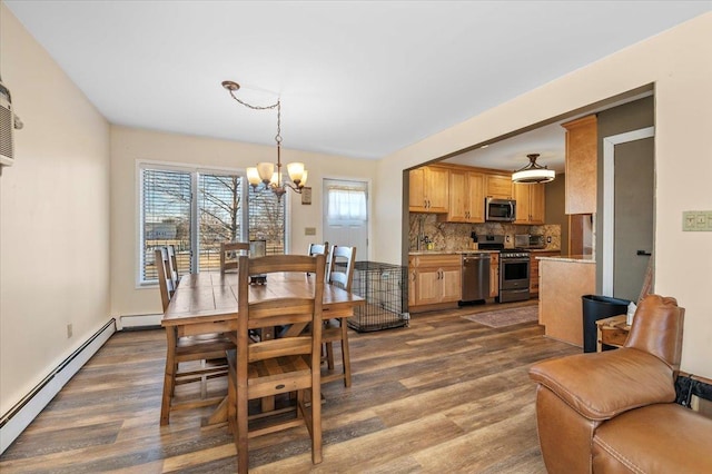 dining space featuring dark hardwood / wood-style flooring, an inviting chandelier, and baseboard heating