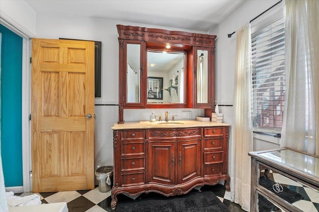 bathroom with vanity and tile walls