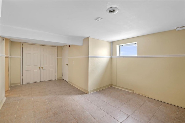 basement featuring light tile patterned flooring