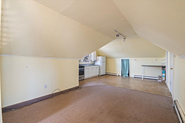 additional living space with lofted ceiling, a baseboard heating unit, and carpet flooring